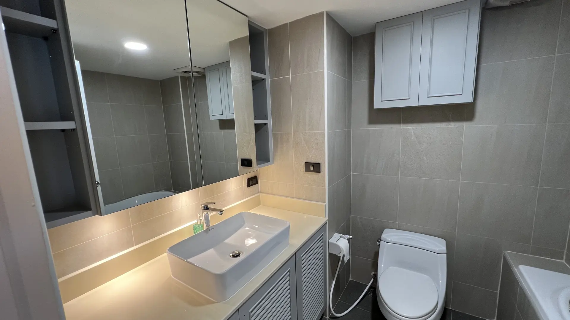 Bathroom with floating vanity, vessel sink and backlit mirror