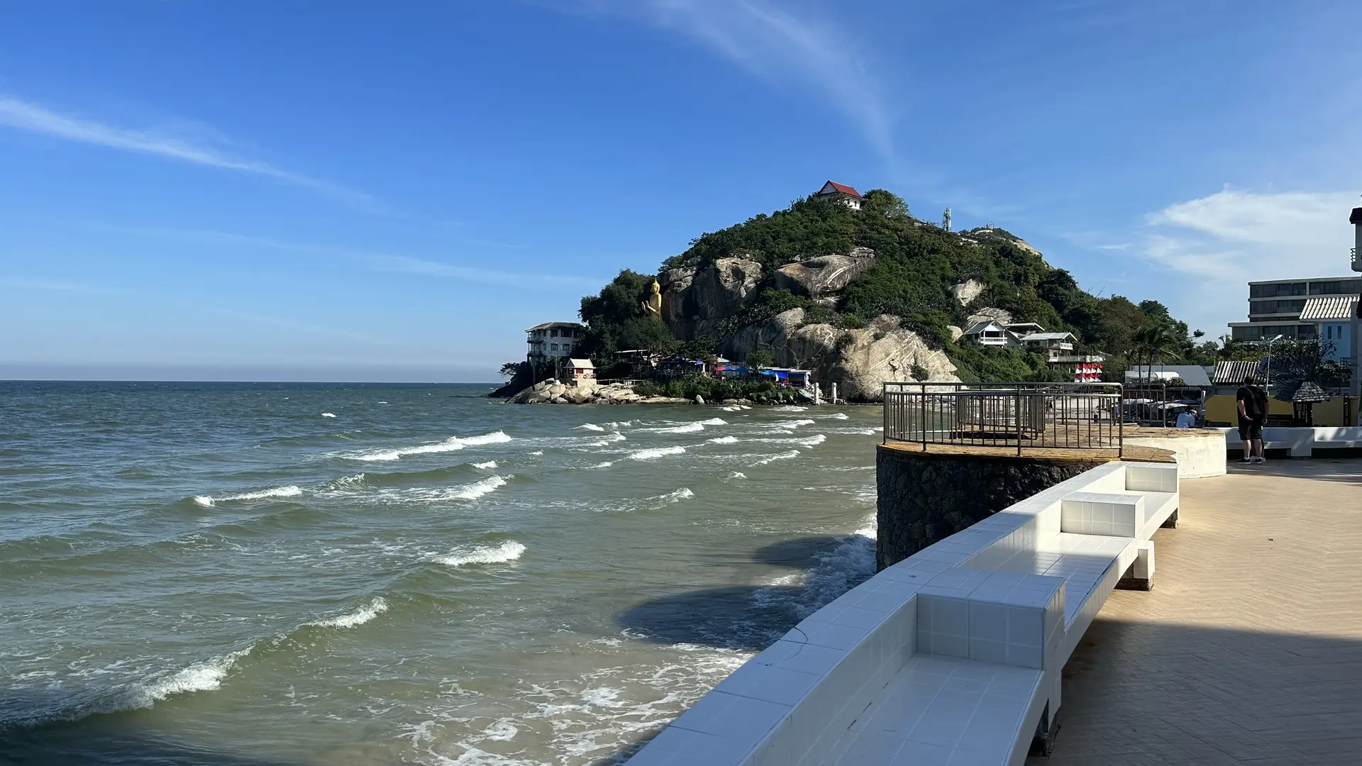 Beachfront promenade and waves below Monkey Mountain
