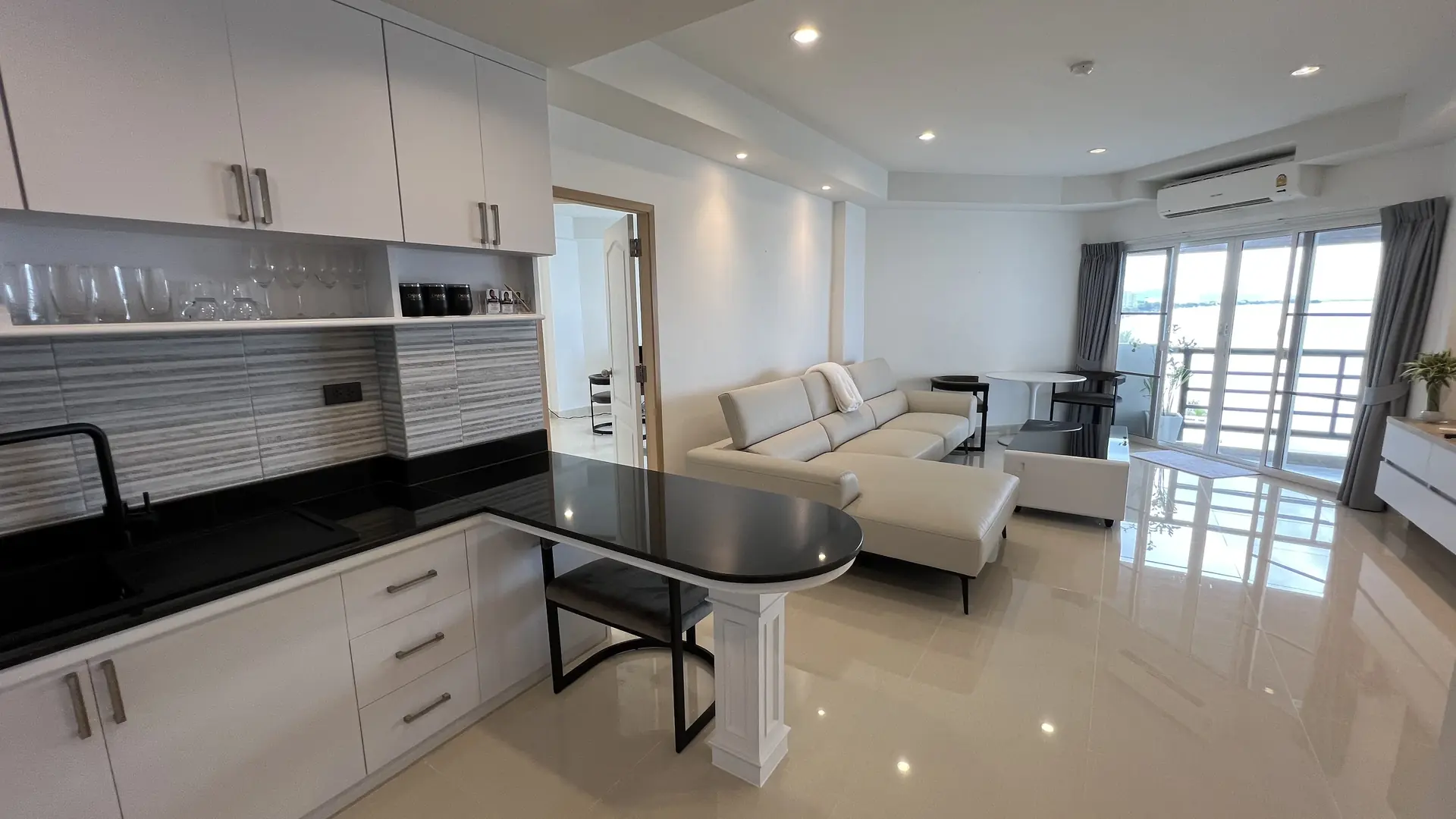 Open kitchen and dining counter flowing into the living room